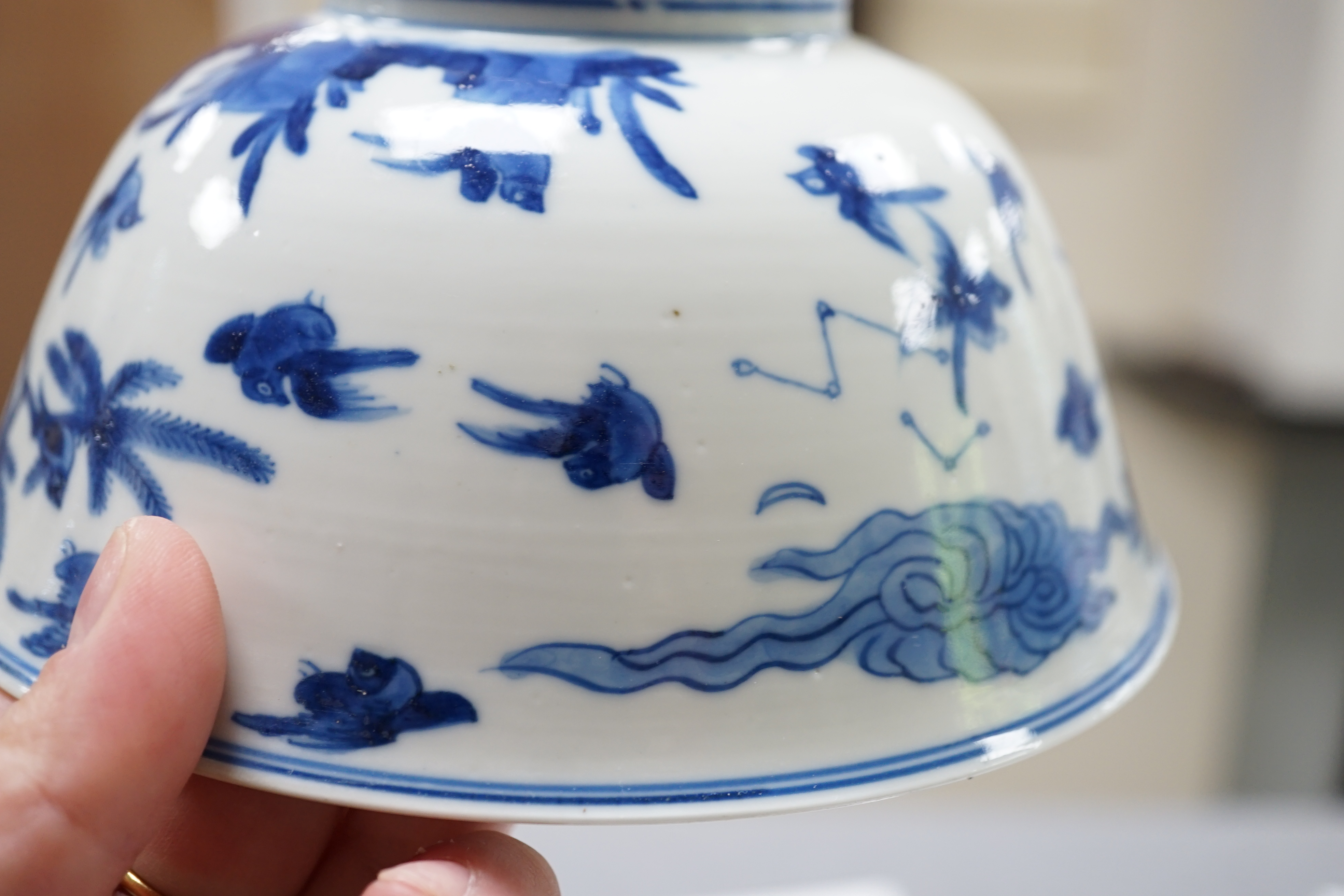 A near pair of Chinese blue and white ‘birds’ bowls, Kangxi period, one bowl restored